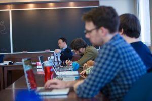 Graduate students take notes in a seminar by Professor Martin Pickavé.